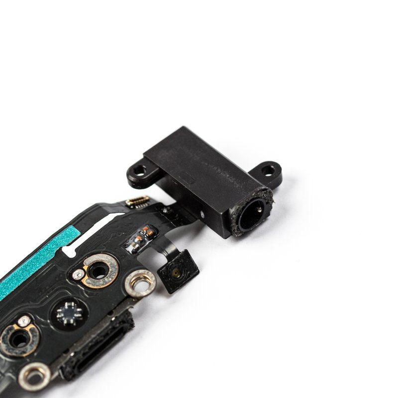 Angled close-up of the flex cable's black headphone jack, screw posts and teal tape, with the gold antenna contacts in the foreground.