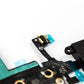 Close macro of the black iPhone 5 charger flex, focused on the small gold contact microphone module on its teal tab above the green shielded main board.