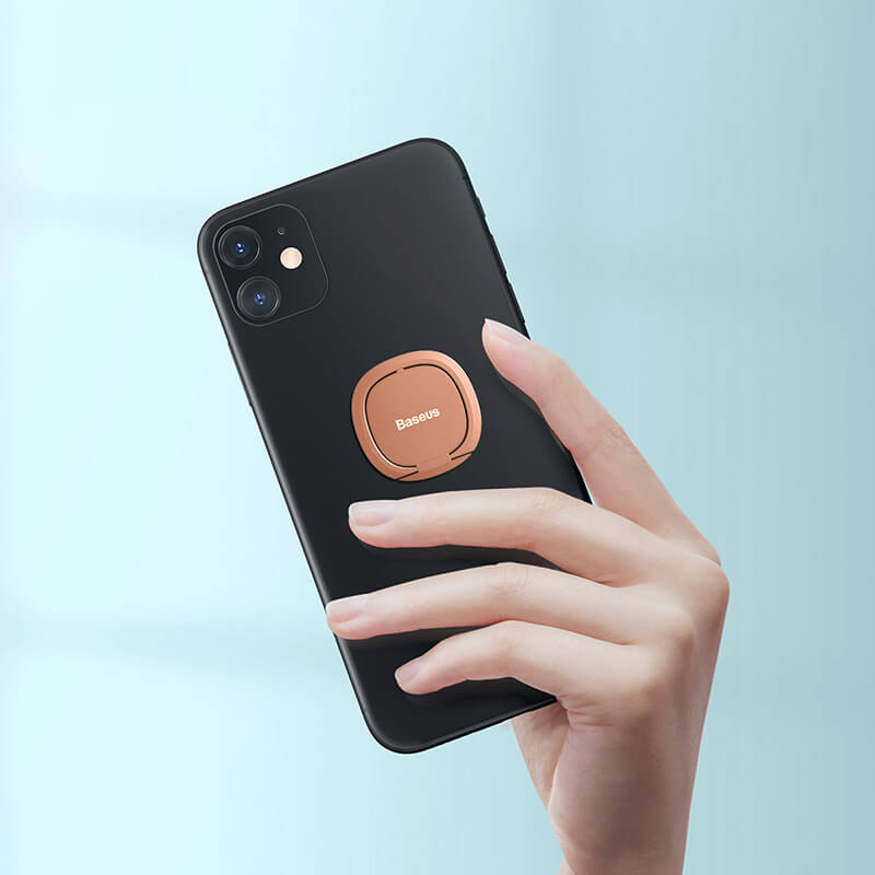 Baseus invisible phone ring rosegold holder attached to a phone holded in hand