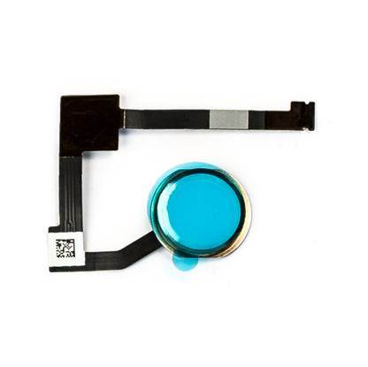iPad home button assembly laid flat, its gold metal ring and button face covered in blue protective film, with the L-shaped black flex and a small QR code sticker.